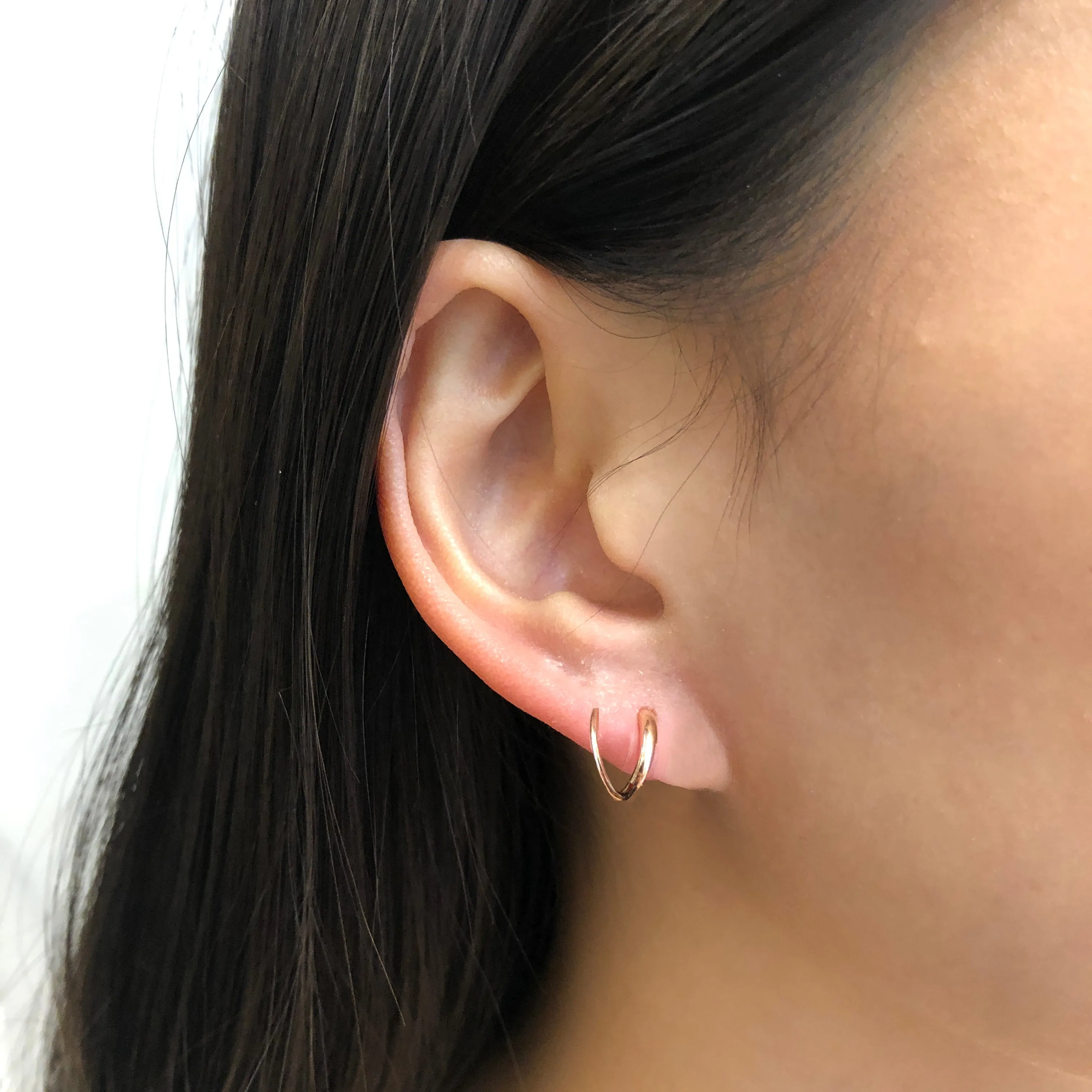 Boucle d'oreille Tusk Twirl de Maria Black, or rose